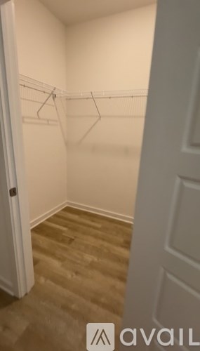 A long flight of wooden stairs leads to a bright window.