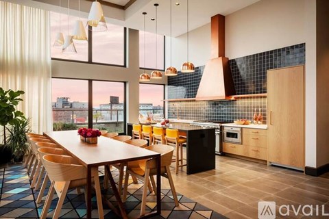 A modern kitchen with a dining table and chairs.