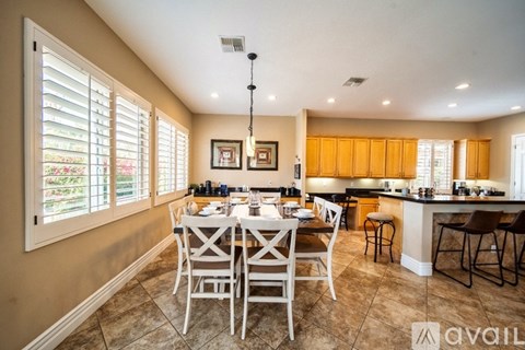 A dining room with a table set for six people.