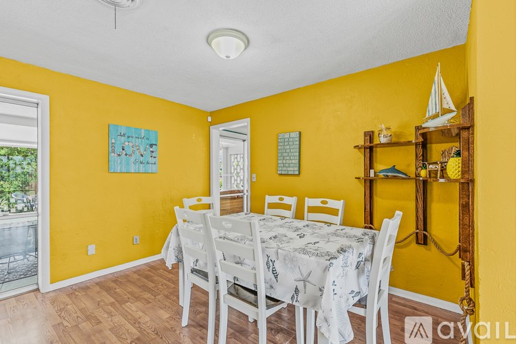 A dining room with a table set for six.