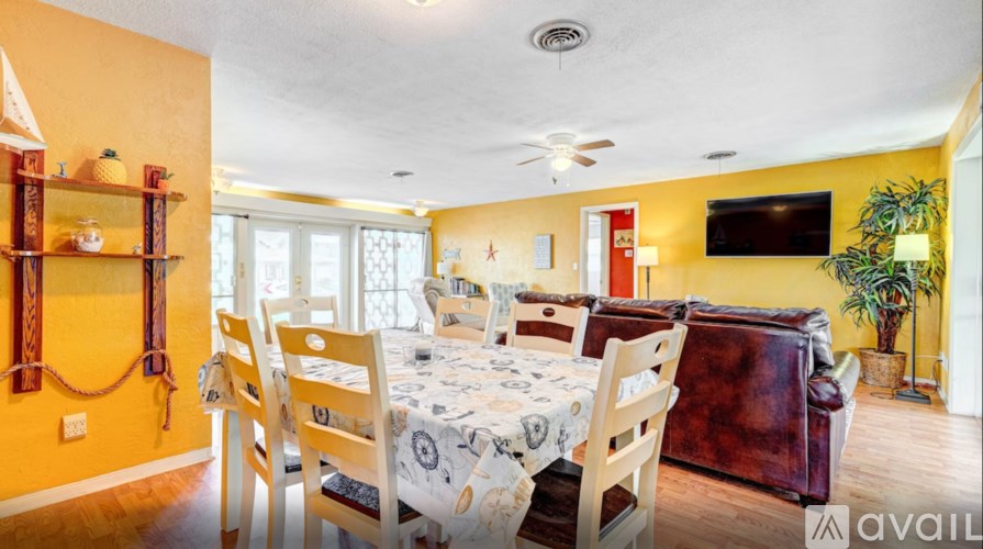 A dining room with a table set for six people.