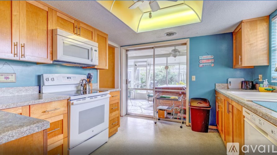 A kitchen with wooden cabinets and a white oven.