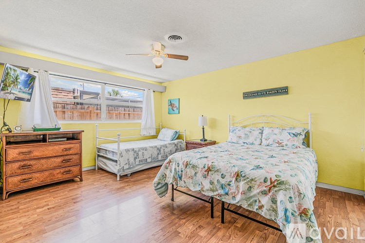 A bathroom with a large mirror, a sink, and a towel rack.