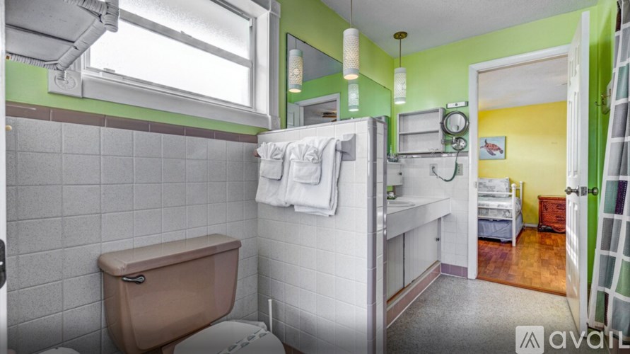 A bathroom with a brown tub and white tiles.