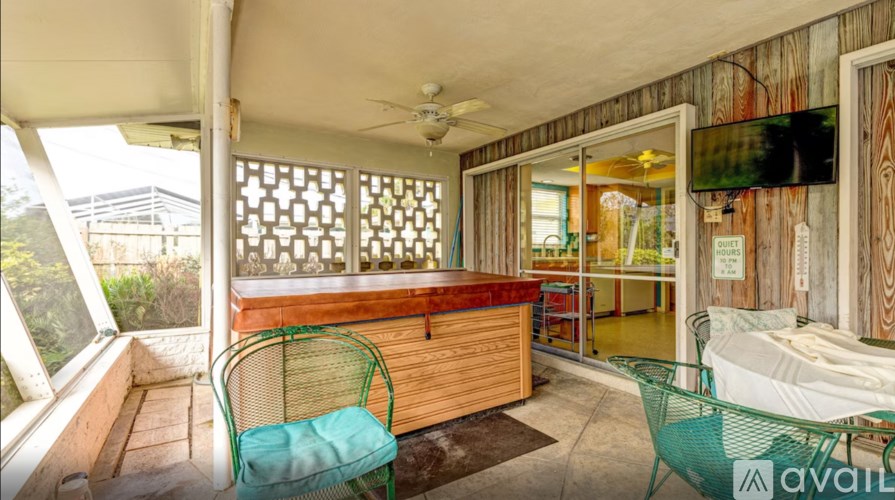 A room with a wooden wall and a ceiling fan.