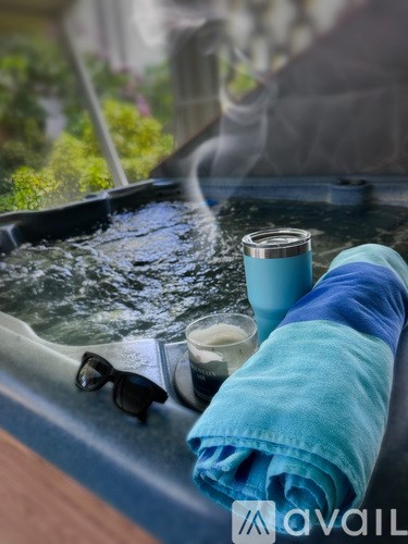 A blue towel is draped over the edge of a hot tub.