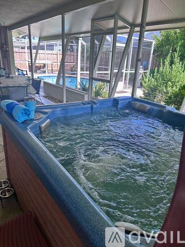 A hot tub with a blue towel on the side.