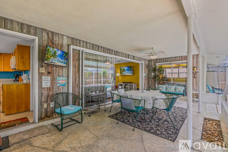 A patio area with a table and chairs.
