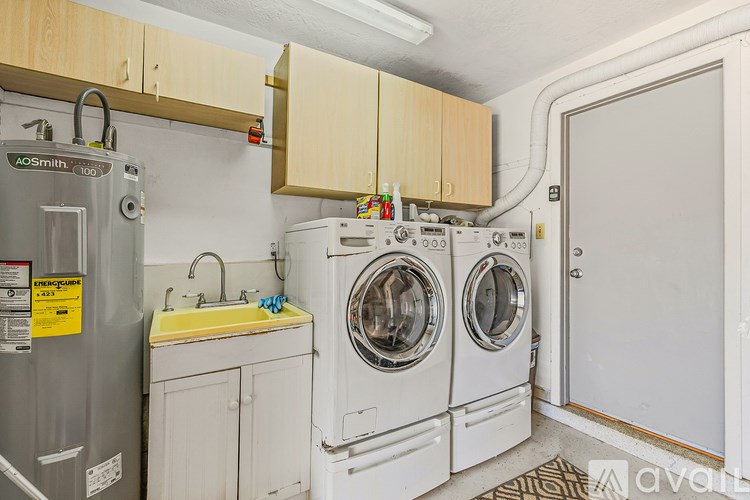 A small laundry room with a washer and dryer.