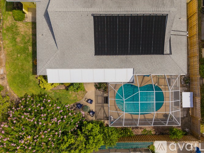 A house with a pool and a car parked in front.