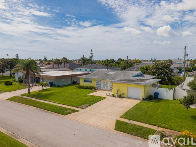 A house with a yellow garage is for sale.
