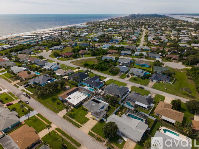 A bird's eye view of a residential neighborhood with houses and streets.