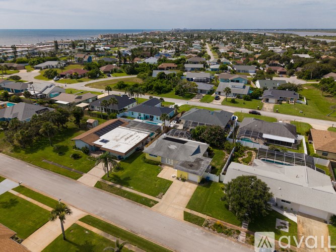 A bird's eye view of a residential area with houses and streets.
