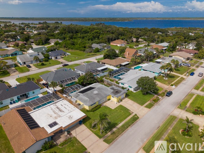 A bird's eye view of a residential area with houses and a road.