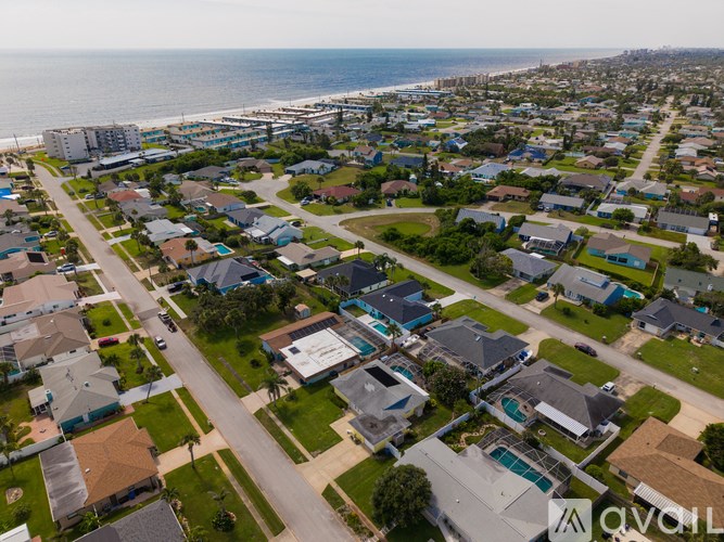 A bird's eye view of a residential neighborhood with houses and streets.