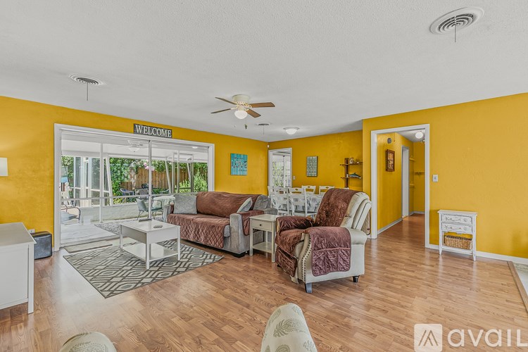 A living room with a white sofa and a wooden bench.