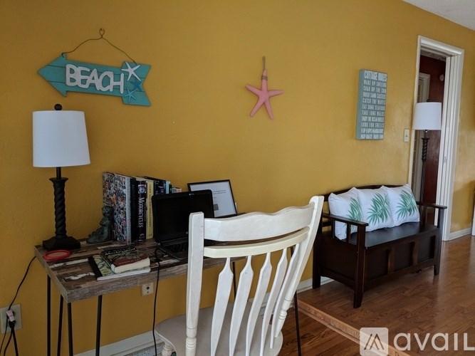 A room with a yellow wall has a sign that says "BEACH" on it.