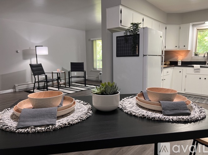 A modern kitchen with a dining table set for two.