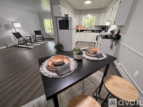 A modern kitchen with a dining table set for two.