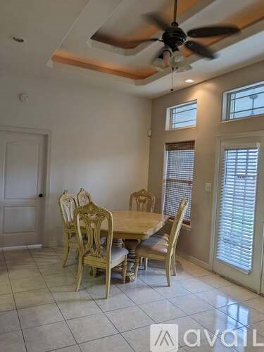 A dining room with a table and chairs.