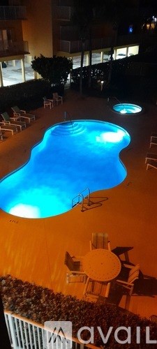 A swimming pool lit up at night.
