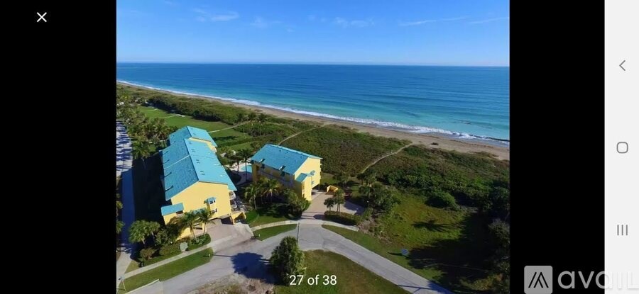 A beachfront property with a yellow and blue building.