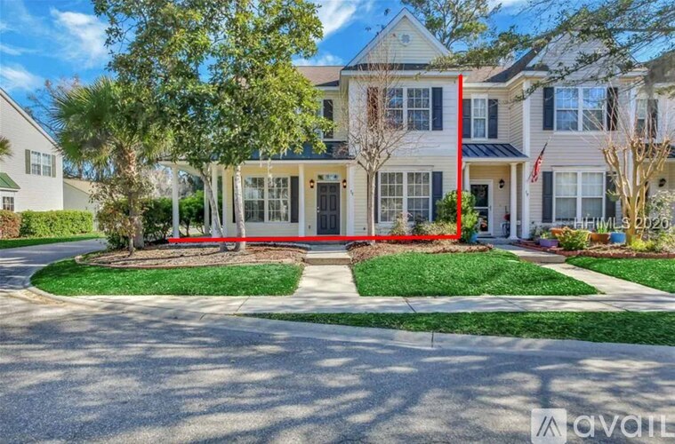 A house with a red fence in front of it.