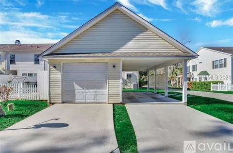 A house with a garage is for sale.