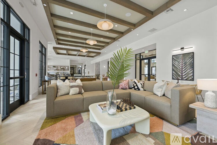 A living room with a large couch and a coffee table.