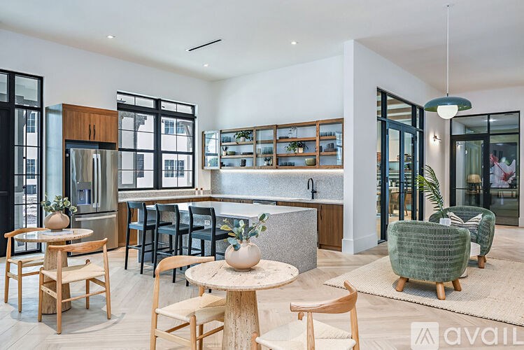 A modern kitchen and dining area with wooden furniture and a large island.