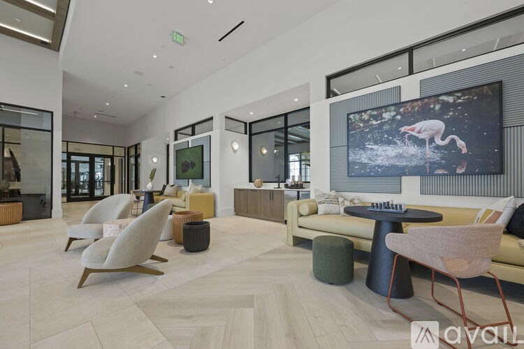 A living room with a large screen on the wall and a couch.