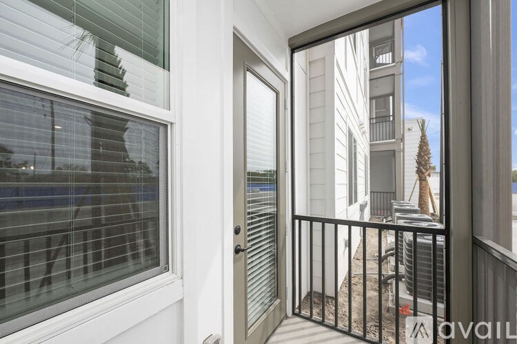 A balcony with a black railing and a glass door.