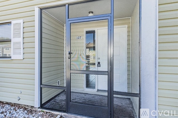A glass door with a handle and a number 127 on the window.