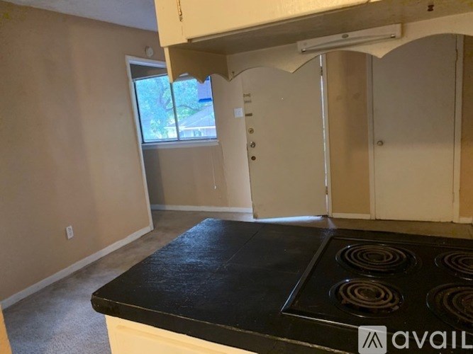 A kitchen with a black countertop and white cabinets.