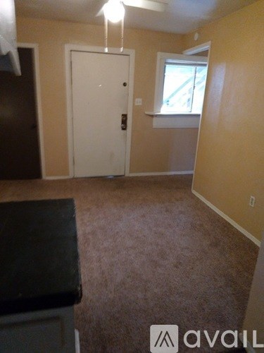 A room with a white door and a window with a white frame.