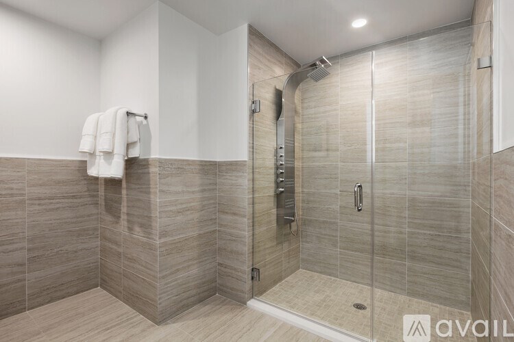 A bathroom with a walk-in shower and a towel rack.