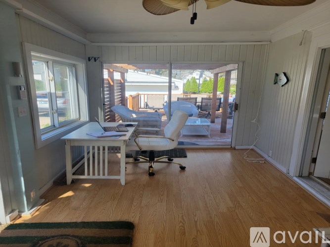 A room with a desk and chair in it.