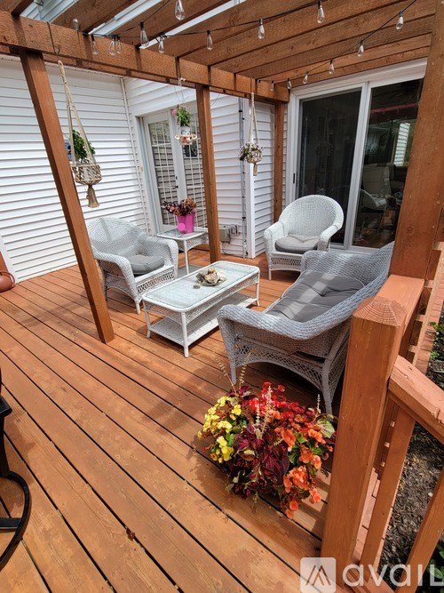 A wooden deck with a table and chairs.