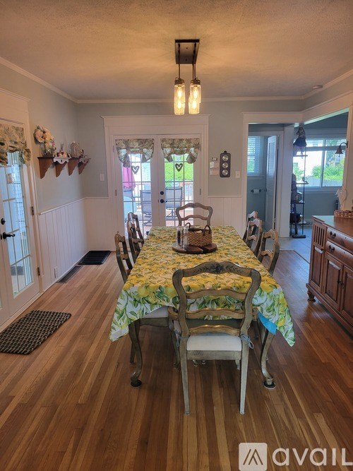A dining room with a table set for four.