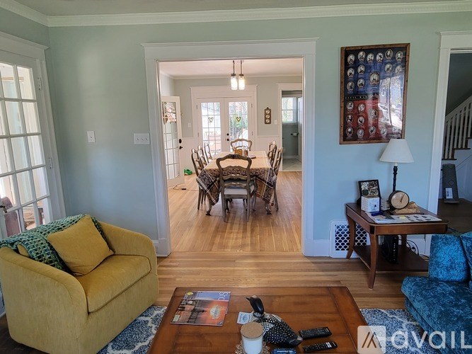 A living room with a yellow couch and a coffee table.