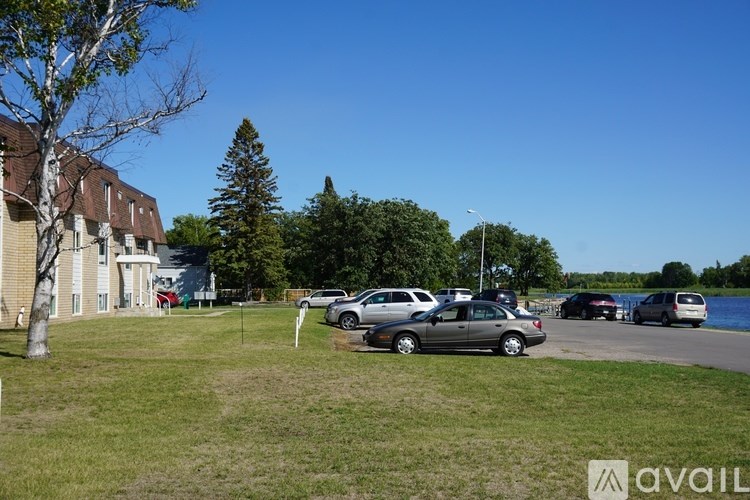 A parking lot with cars and a building in the background.