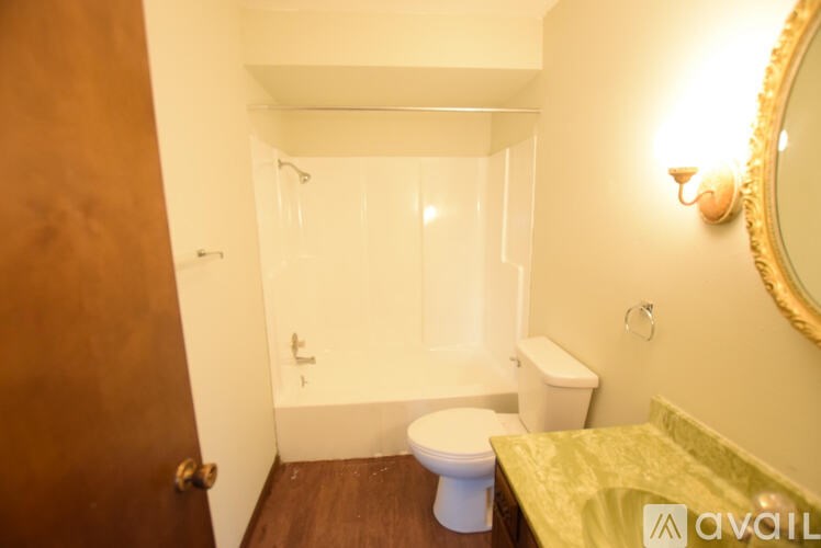 A bathroom with a toilet, sink, and bathtub.