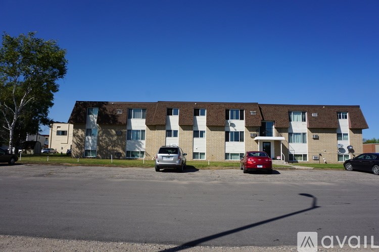 A building with a parking lot in front of it.