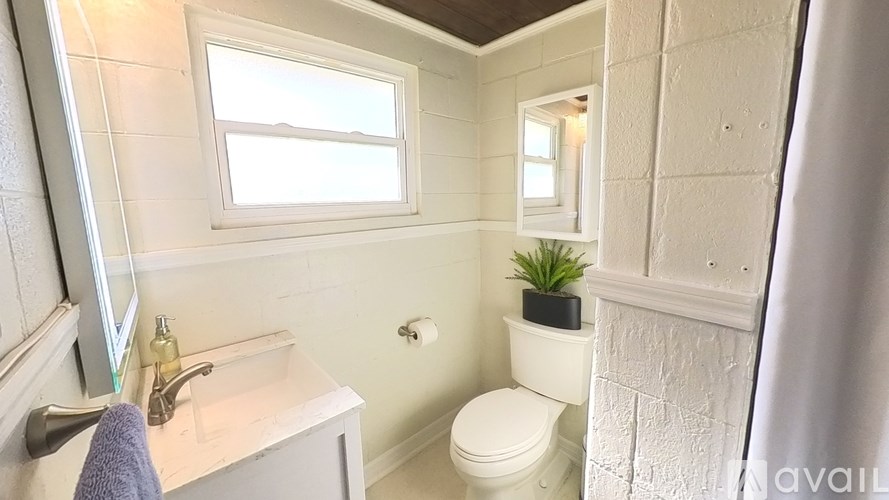 A small bathroom with a toilet, sink, and mirror.