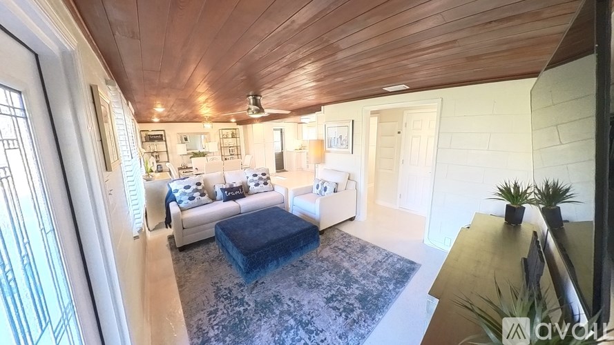 A living room with a couch and a rug.