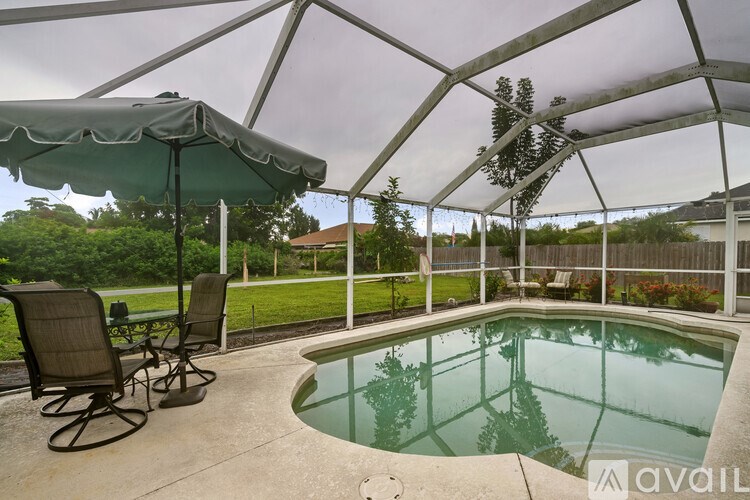 A patio with a table and chairs under a canopy.