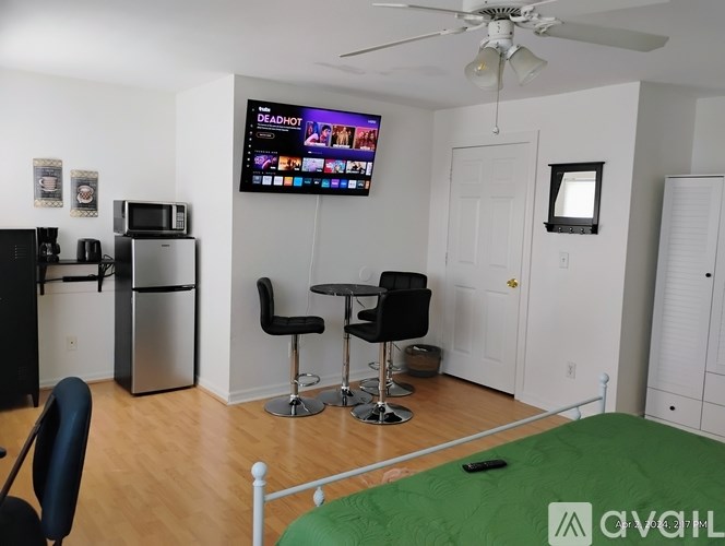 A living room with a TV showing the movie Deadshot.