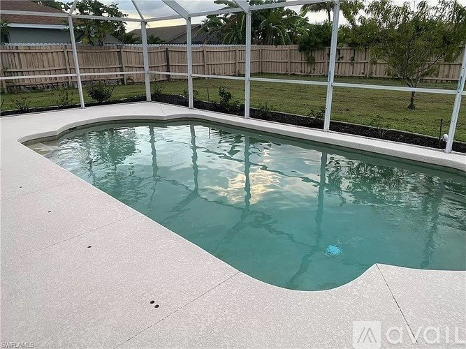 A small pool with a white fence around it.