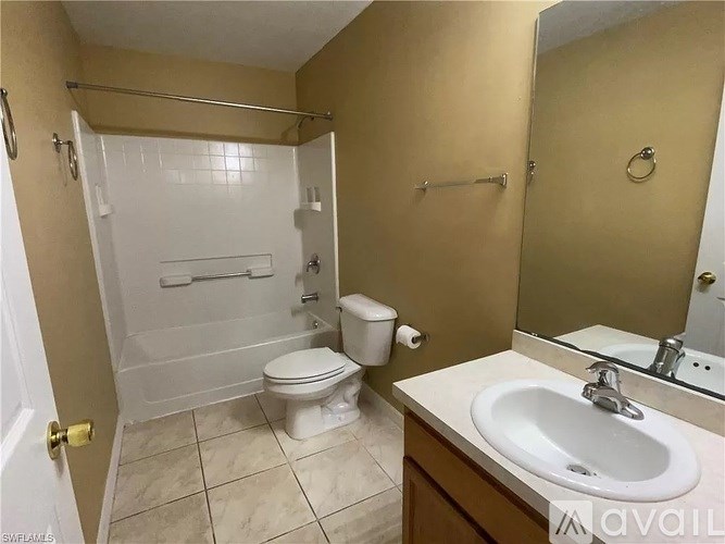 A bathroom with a toilet, sink, and shower.