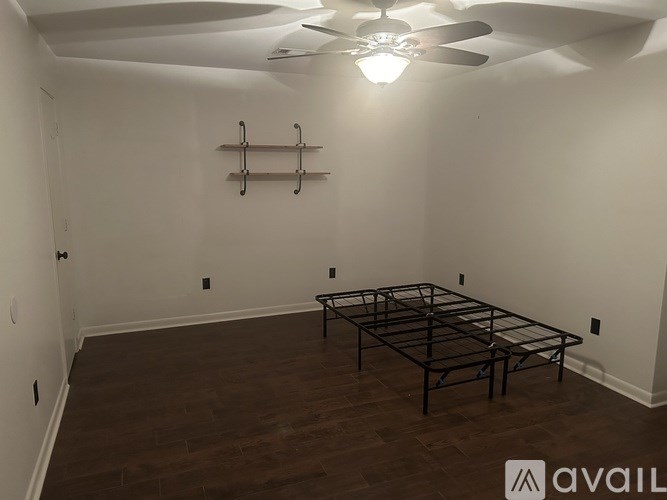 A room with a bed frame in it.